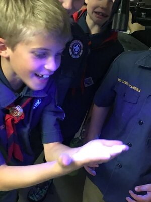 Cub Scout with Hand under UV light